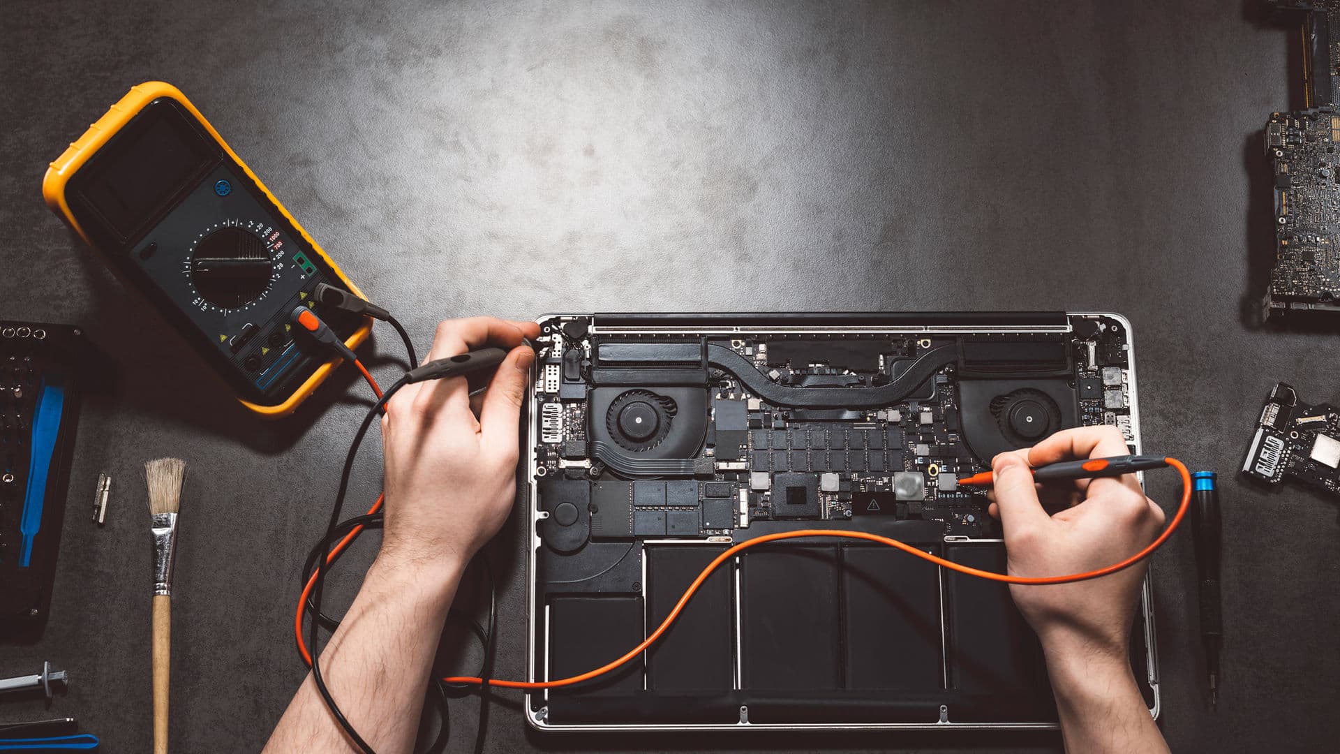 IT technician supporting a customer with computer repair in Kingsbridge